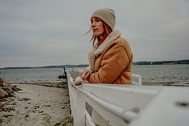 Eine Frau am Winterstrand an der Ostsee